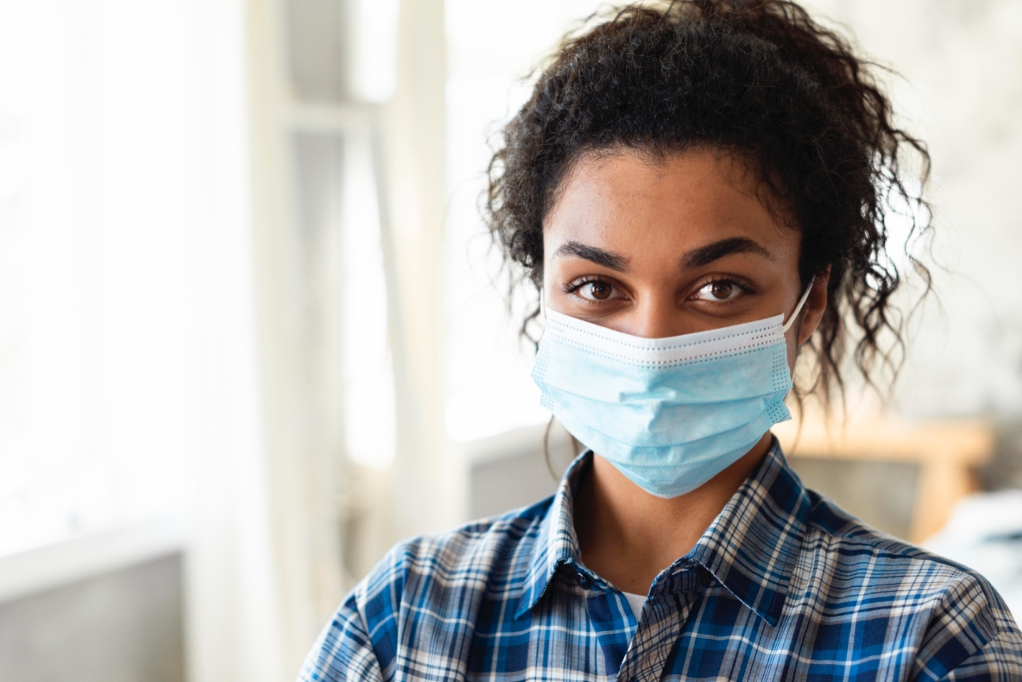 Smiling woman in a facemask